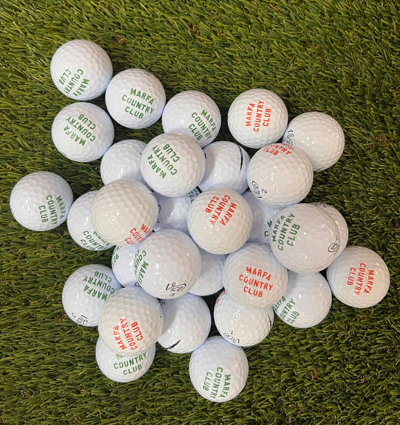 golf balls with 'Marfa Country Club' branding