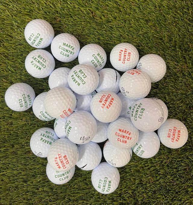 golf balls with 'Marfa Country Club' branding